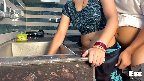 Indian babe in a black dress is drilled in the kitchen