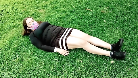 Amateur brunette enjoying stretching her body in the park