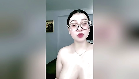 Busty beauty in glasses plays with her body in a sexy way