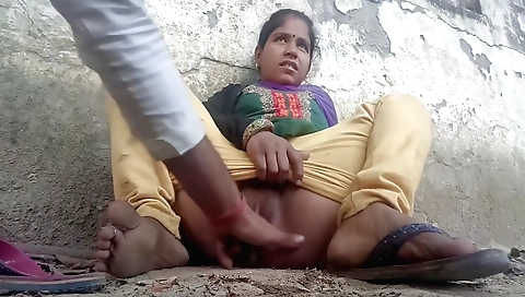 Hot brunette in orange shirt finger in the outdoor