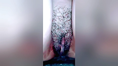 Busty girl is wetting her hairy pussy and she does not know