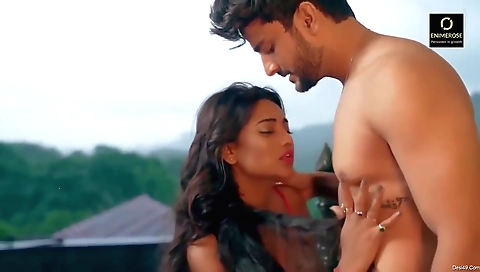 Brunette rides a bike in the park in bikini and boots